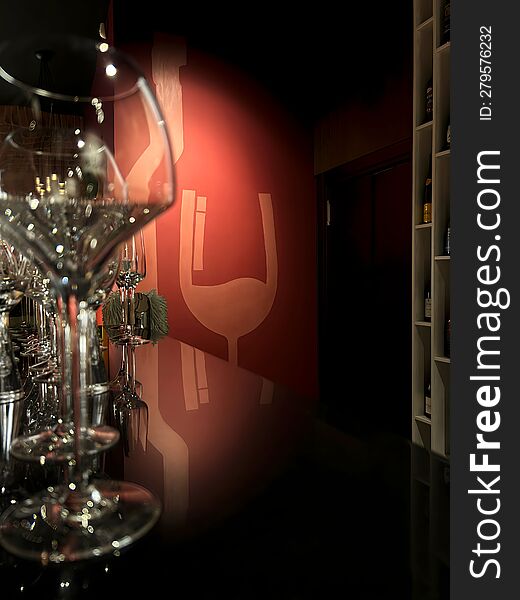 Wine Glasses On A Black Bar Counter In Front Of A Backlit