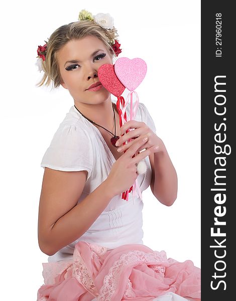 Cute, beautiful, sexy valentine girl holding heart shaped lollipops