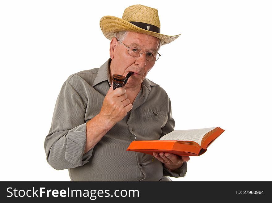 Old man with pipe reading a book - isolated. Old man with pipe reading a book - isolated