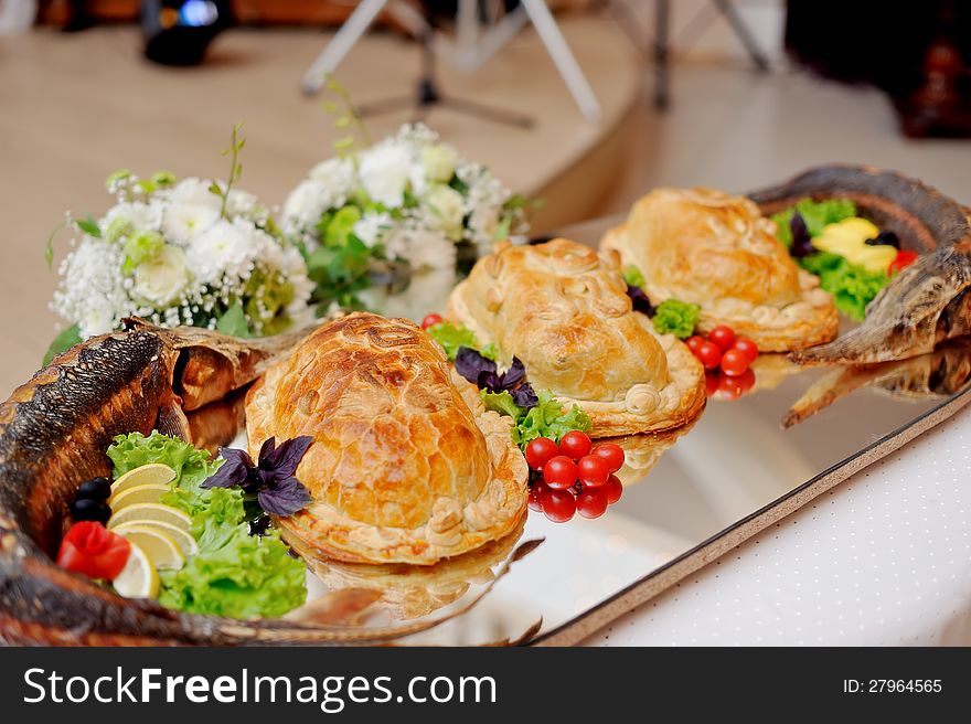 Beautifully designed holiday dish with stuffed fish and pies