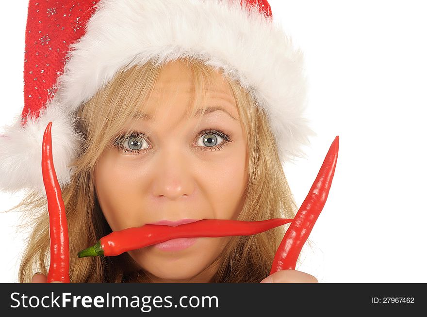 Attractive young woman in Santa Cap with chili pepper. isolated on white. Attractive young woman in Santa Cap with chili pepper. isolated on white.