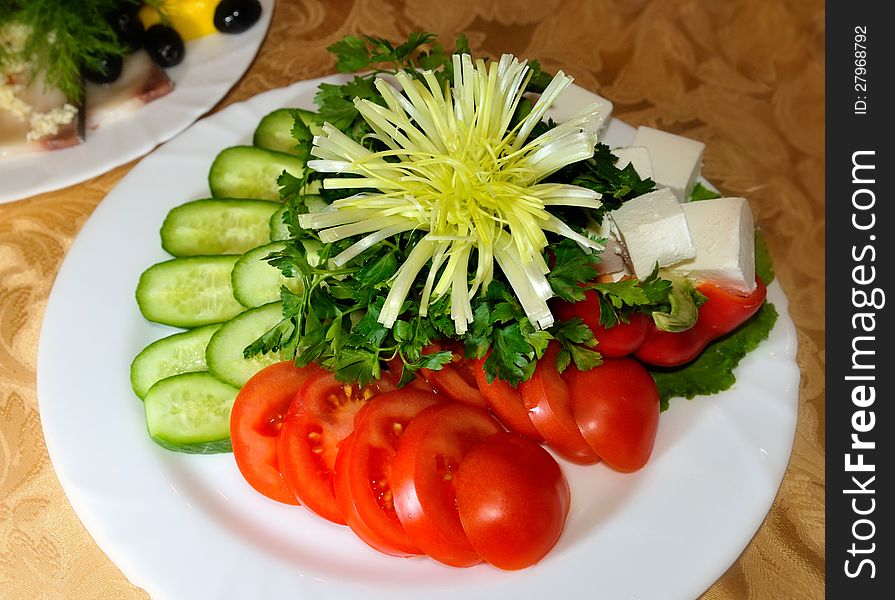 Fresh cucumbers and tomatoes served  with parsley. Fresh cucumbers and tomatoes served  with parsley