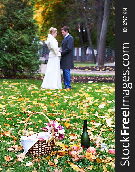 Happy bride and groom in park on picnic