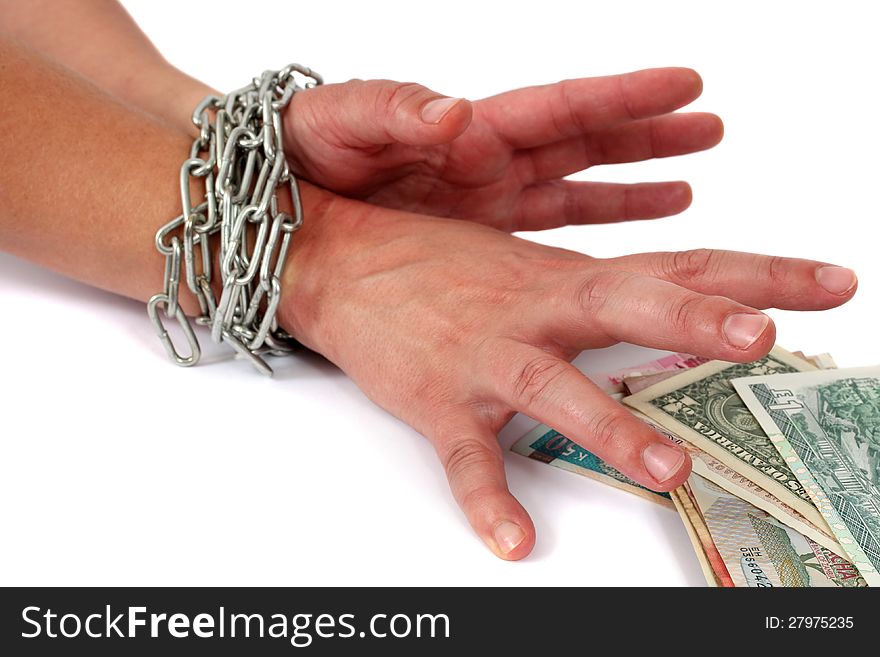 Hands in chains trying to grab money.  Different currencies. Hands in chains trying to grab money.  Different currencies.