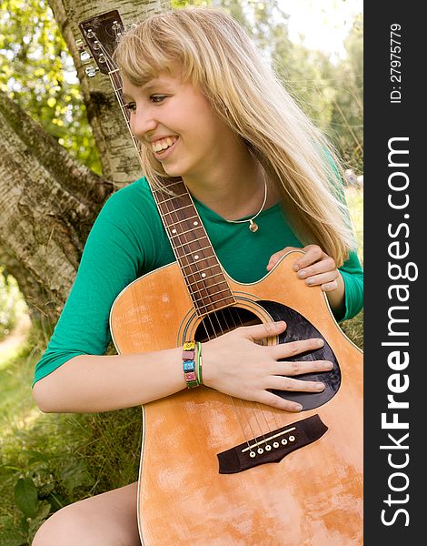 Smiling with her guitar