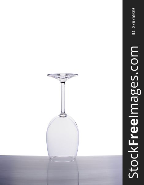 Inverted empty wine glass isolated on white background