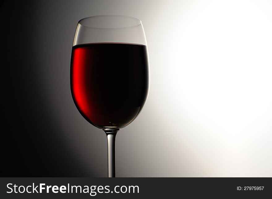 Closeup of red wine wineglass on dark background