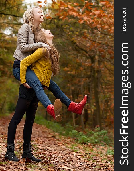 2 girls are having fun in the forest. 2 girls are having fun in the forest