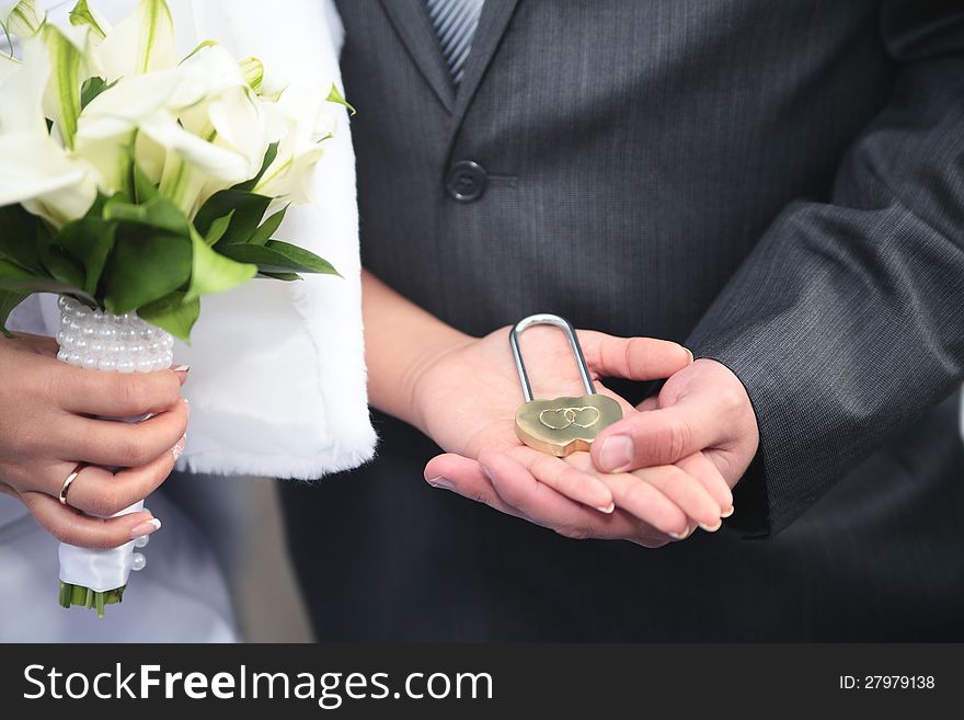 The lock in hands of newlyweds,new family