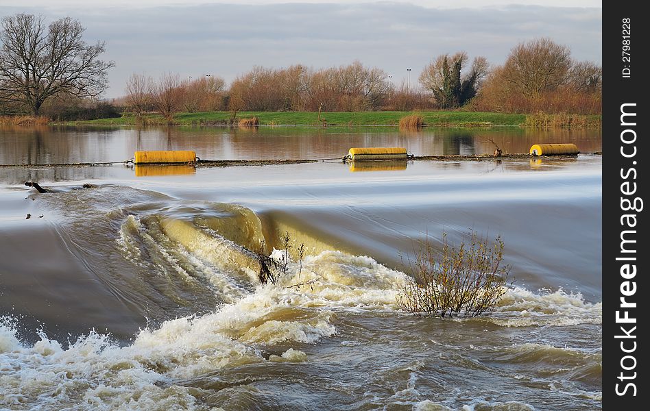 Flood water passing over a Weir