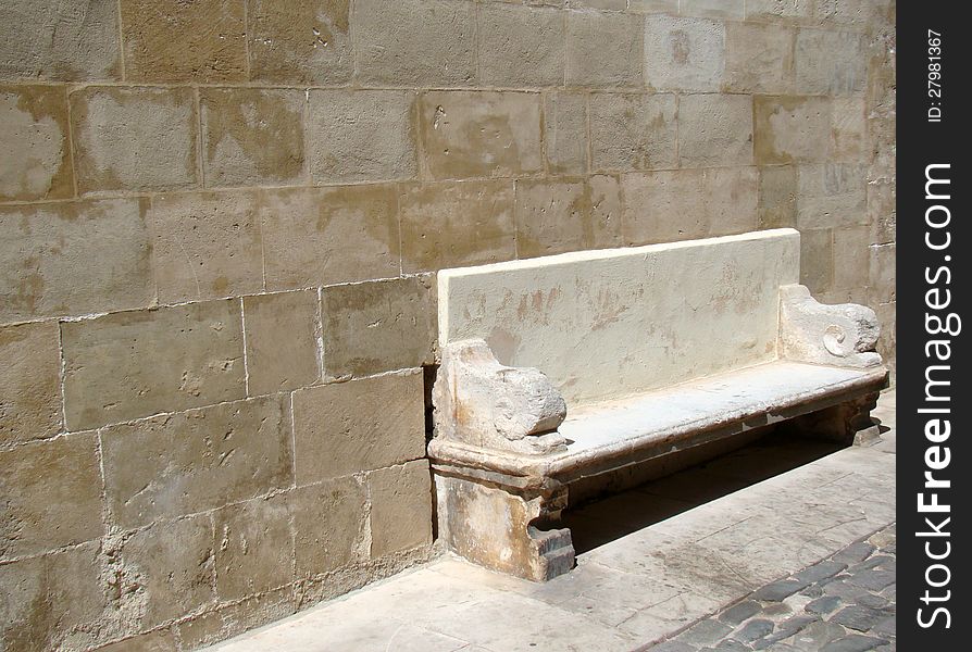 Old stone bench in historic part of town Mahon, Menorca, Spain