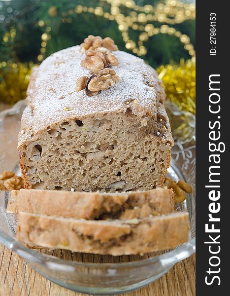 Christmas Banana cake with walnut dusted with icing sugar closeup