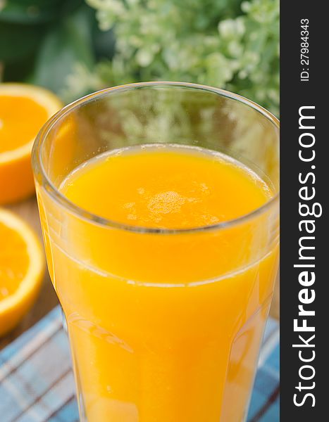 Glass of orange juice closeup selective focus