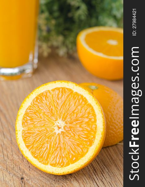 Orange cut in half on a wooden table. Orange cut in half on a wooden table