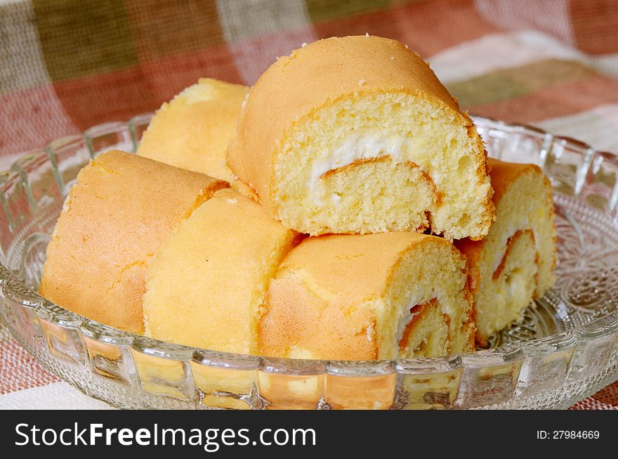 Serving of cake roll with white cream. Serving of cake roll with white cream.