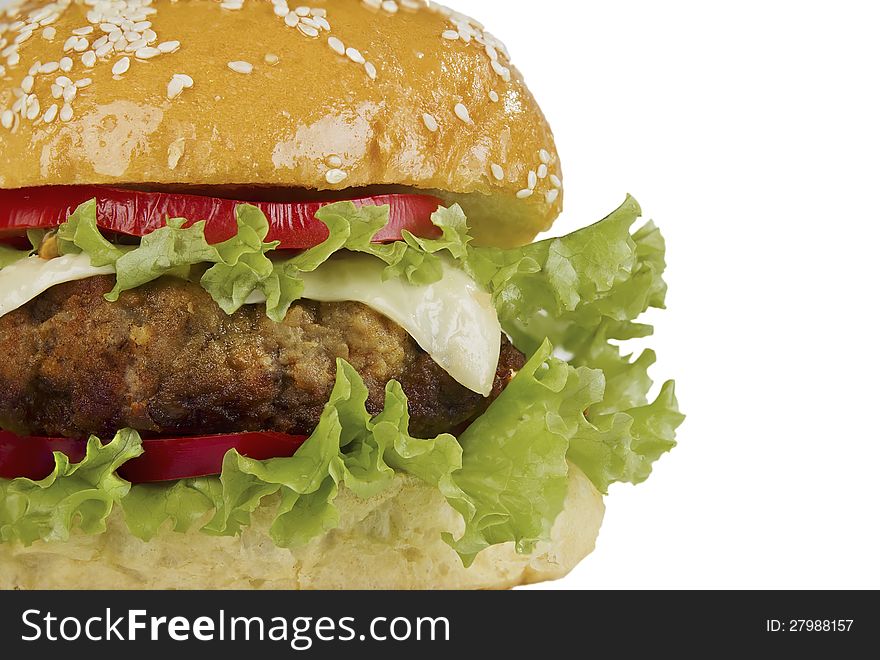 Cheese burger with lettuce cheese and tomato, isolated over white,  close up. Cheese burger with lettuce cheese and tomato, isolated over white,  close up.