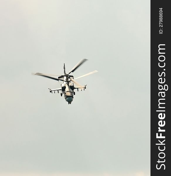 Perform aerobatics by the modern russian attack helicopter Ka-50 at the airshow. Perform aerobatics by the modern russian attack helicopter Ka-50 at the airshow