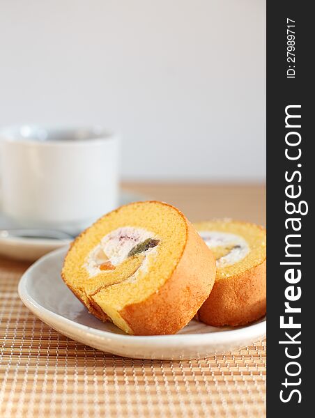 Roll cake with cup of tea