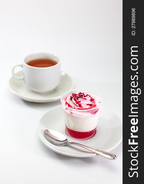 Close up strawberry pudding and cup of tea on white background