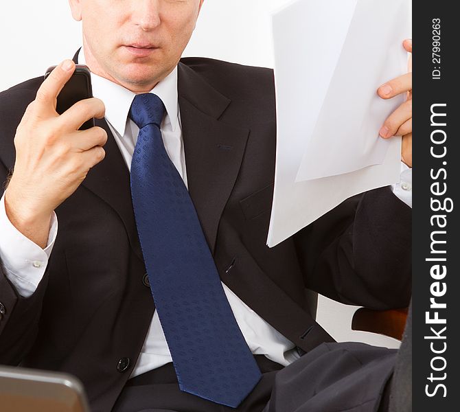 Businessman reading a letter and calls on his mobile phone. Close-up on a white background.