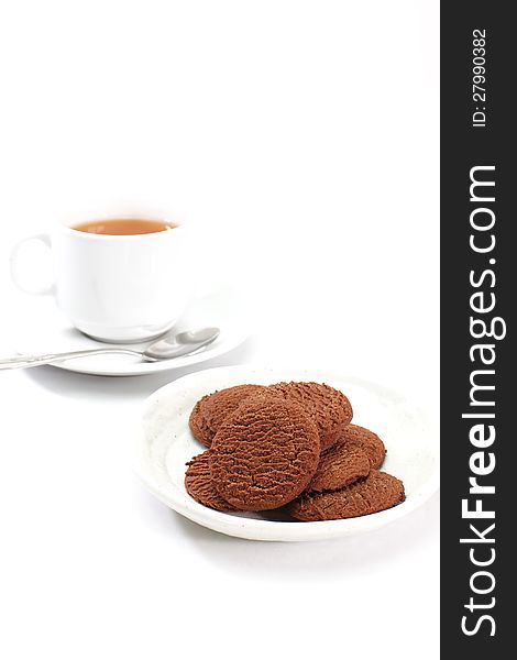 Chocolate cookies and cup of tea on white background
