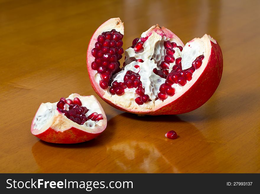 Ripe pomegranate on a wooden table top