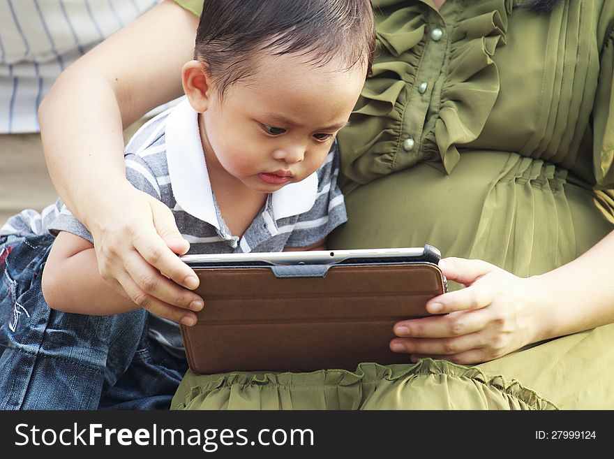 Little boy and his mother using a tablet