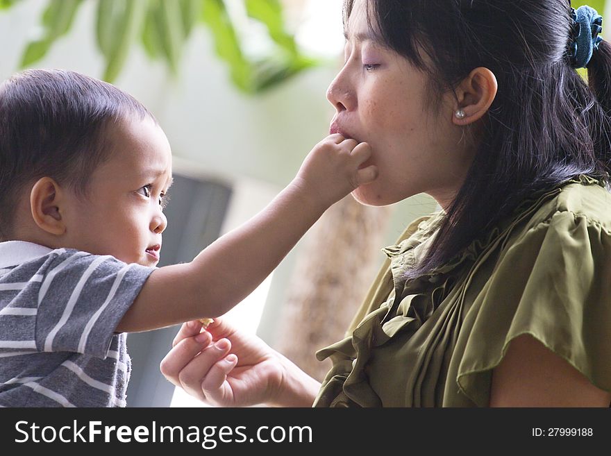 Little boy. Feeding pregnant mother. Little boy. Feeding pregnant mother