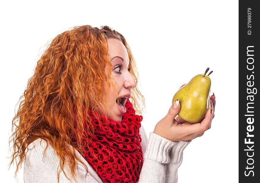 Surprised red-haired girl with a pears isolated on white