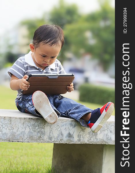 Little boy staring at a tablet computer