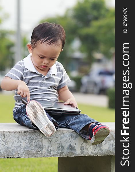 Little Boy Using A Tablet