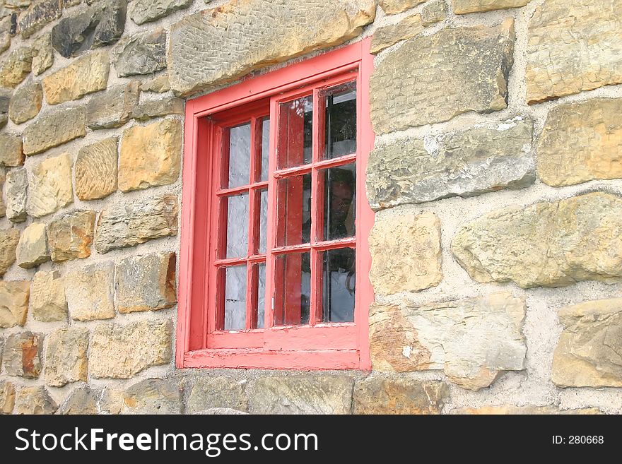 Small Red Window in a Stone Wall