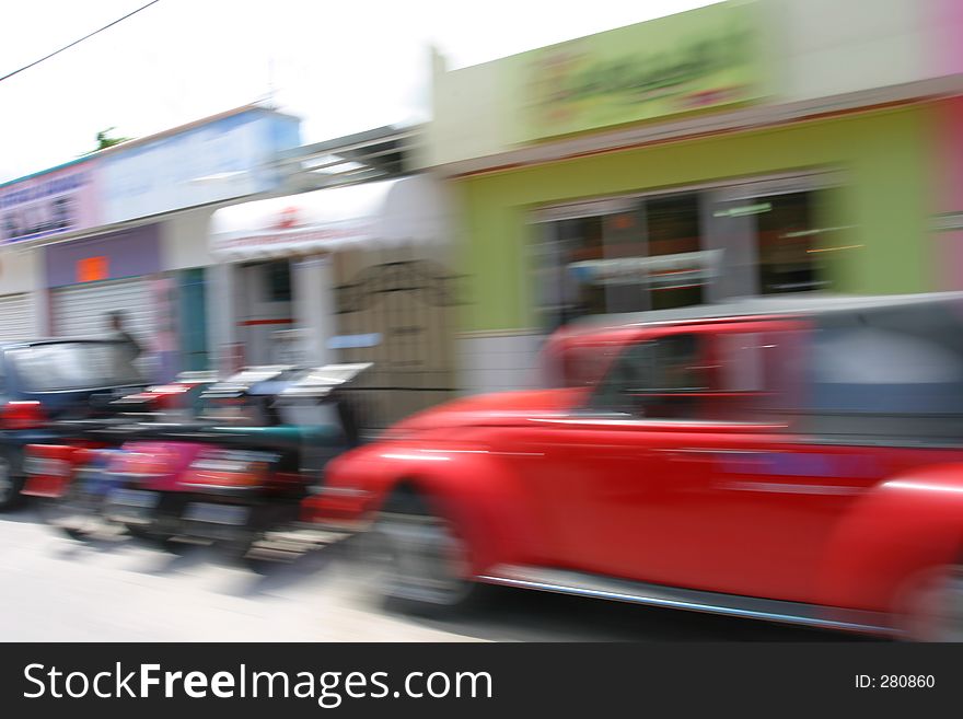 Shot with a slow shutter speed to blur vehicles and people so that it creates a feeling of motion or speed. Shot with a slow shutter speed to blur vehicles and people so that it creates a feeling of motion or speed.