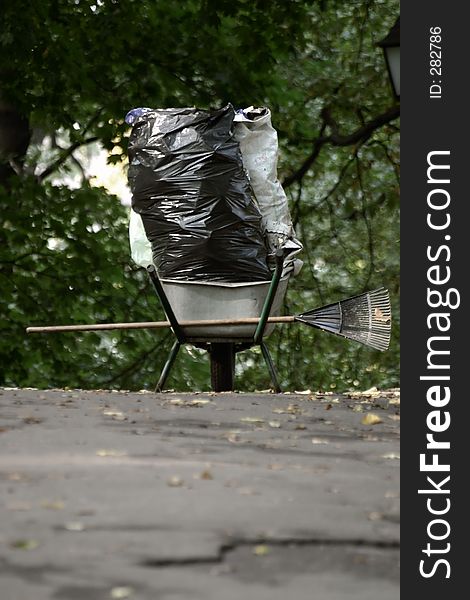 Gardeners wheelbarrow with a autumn trash