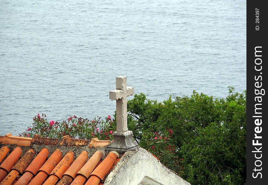 Stone textured cross on the roof