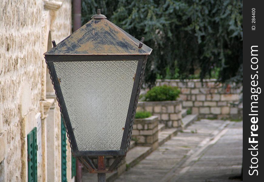 Stylish lantern on the stone wall