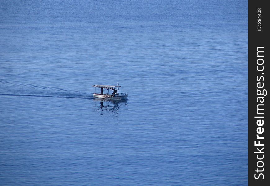 Fisherman on the blue sea