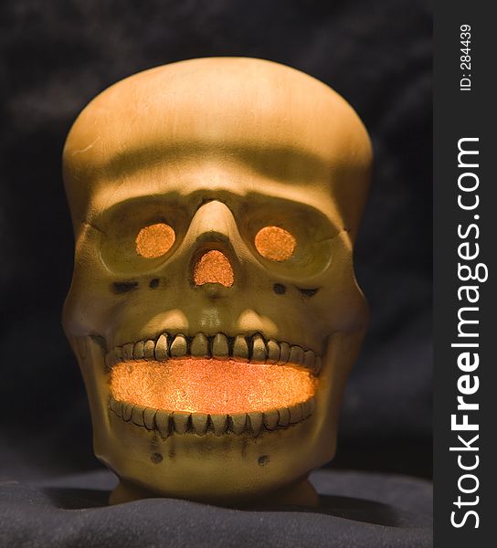A Halloween skull made out of ceramics with light in it. A Halloween skull made out of ceramics with light in it.