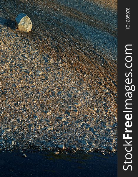 A rocky shoreline or a river with gravel and rocks.