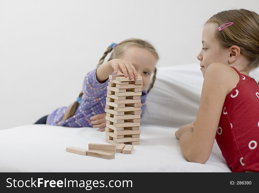 Girls playing. Focus on the fingers / blocks. Girls playing. Focus on the fingers / blocks