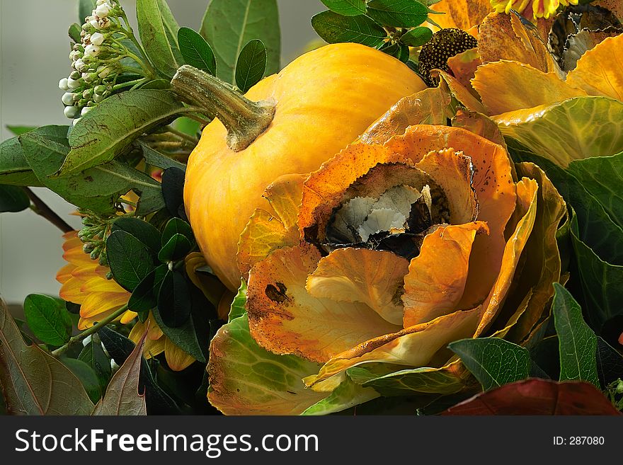 Autumn decoration with pumpkin and flowers