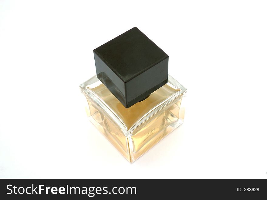 A square perfume bottle with brown cap