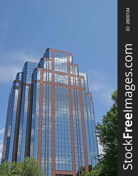 A brick and glass office building against blue sky. A brick and glass office building against blue sky