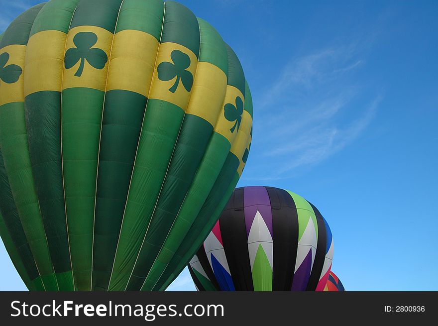Closeup of colorful hot air balloons against  the blue summer sky