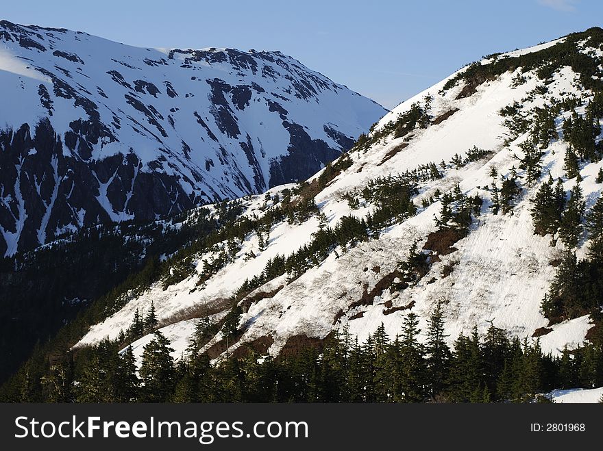 The sunny and shadow sides of mountains in Juneau, Alaska. The sunny and shadow sides of mountains in Juneau, Alaska.
