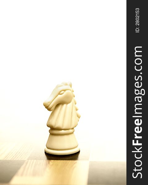 Picture of a knight figure on chessboard