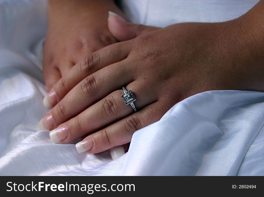 Closeup of a bride's hands and engagement ring just before her wedding ceremony. Closeup of a bride's hands and engagement ring just before her wedding ceremony