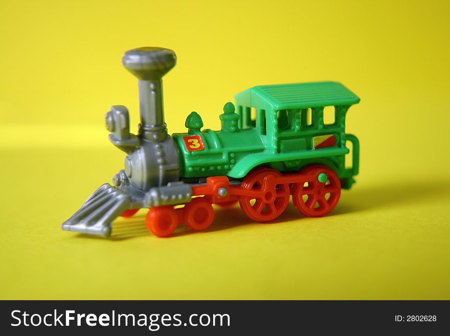 A colorful and very small toy locomotive