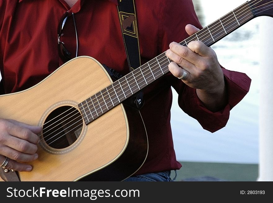 Man playing an acoustic guitar. Man playing an acoustic guitar