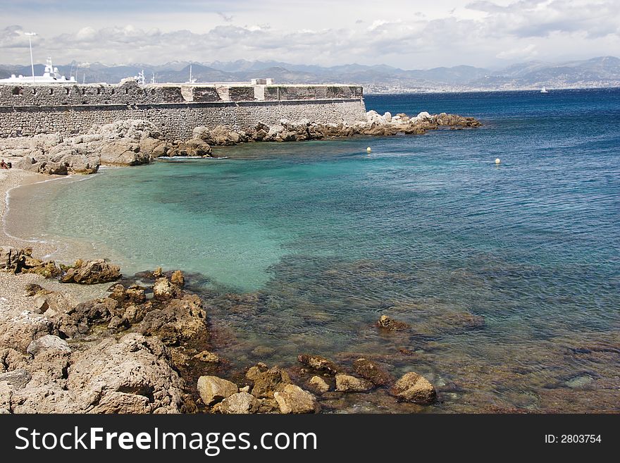 Antibe beach, France with port wall in distance